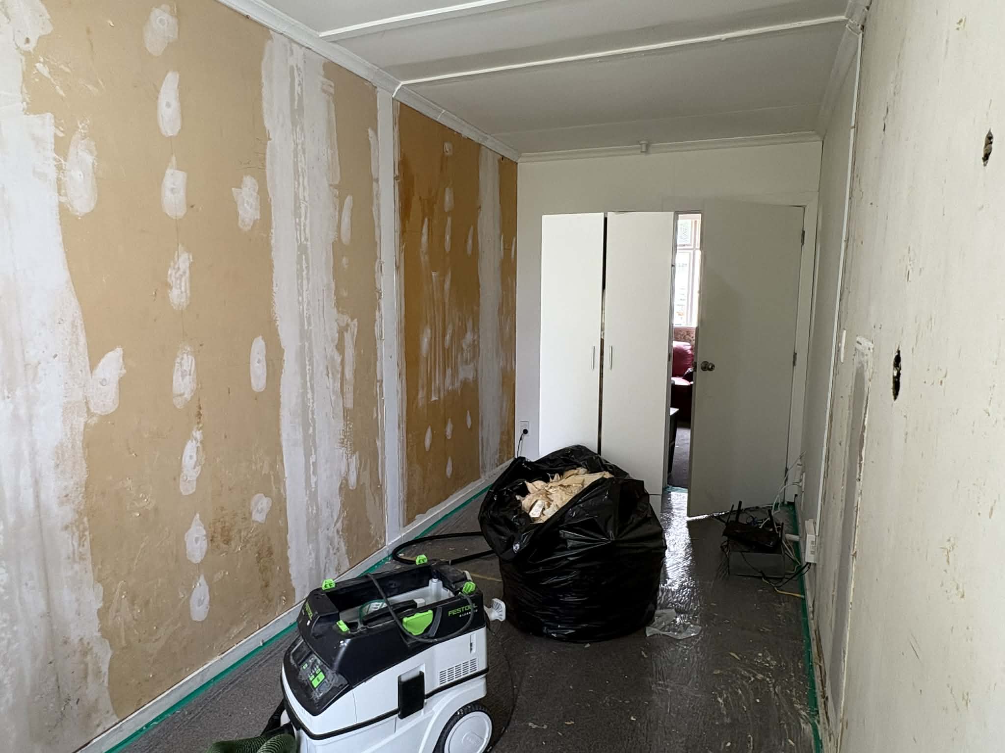Interior repaint preparation in Dunedin — patched areas sanded and ready for paint