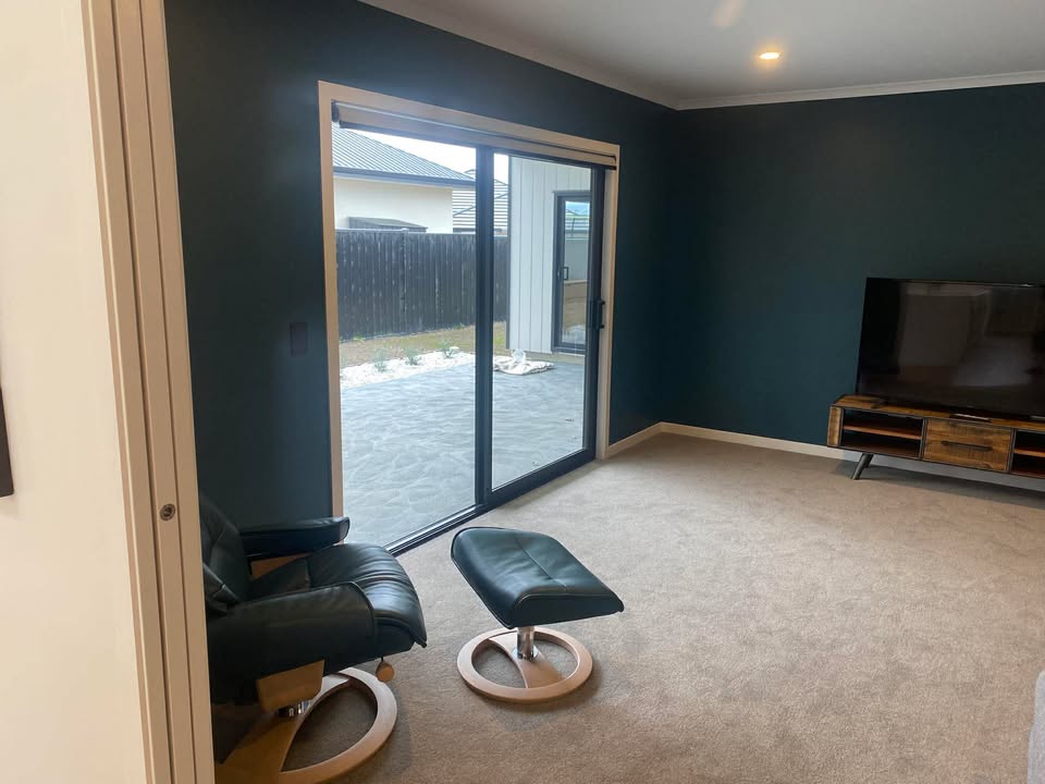 Showhome interior painting in Dunedin with large sliding doors and outdoor view