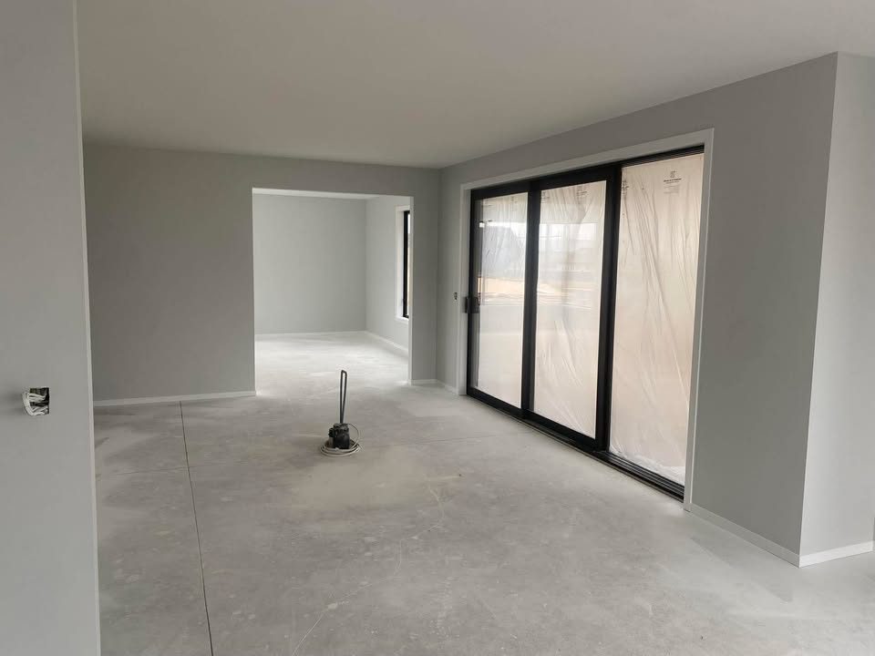Completed open-plan kitchen and living area with smooth ceilings and broadwalls